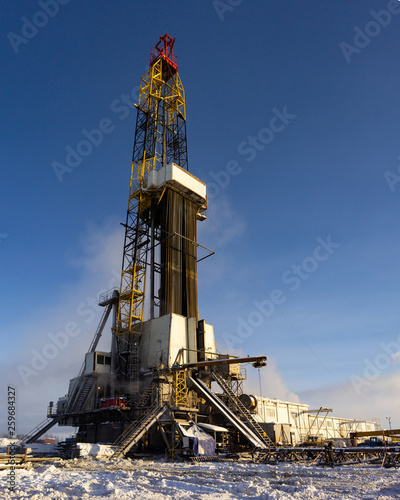drilling rig tower vertically on a winter morning