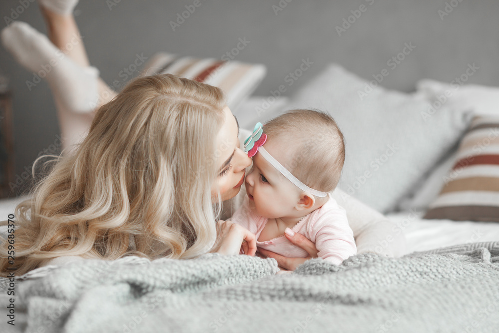 Young mother with her little cute baby daughter. Little baby girl and her  mom. Mama with her child indoor. Stock Photo | Adobe Stock