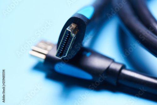 Black HDMI cable adapter connector on a blue background isolated photo