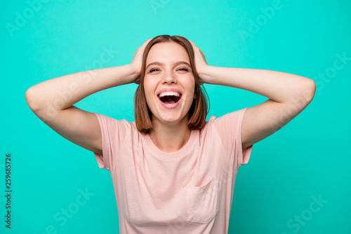 Portrait of charming pretty teen teenager astonished impressed discounts news information black friday bargain scream shout touch head laugh laughter pastel colored outfit isolated teal background