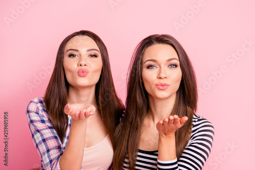 Close-up portrait of nice-looking attractive lovely winsome sweet girlish cheerful straight-haired girls wearing casual sending you kiss isolated over pink pastel background