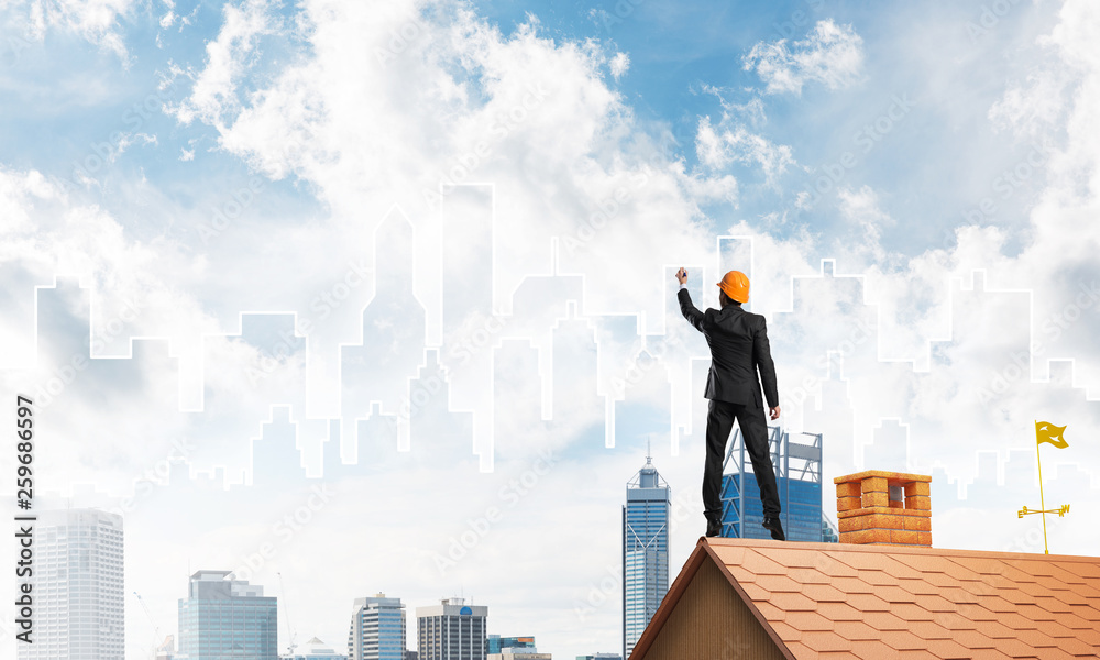 Man architect draw silhouette of modern city on blue sky. Mixed media Man architect draw silhouette of modern city on blue sky. Mixed media