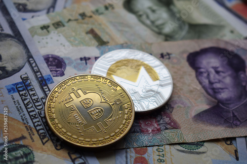 Bitcoin BTC and Monero XMR Coins on Chinese Yuan and US dollar banknotes.