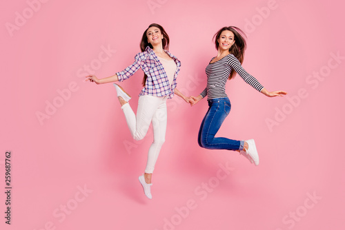 Full length body size view photo of cute pretty students millennial having walk fooling isolated feeling freedom hold hand excited dressed denim checkered clothes on rose-colored background