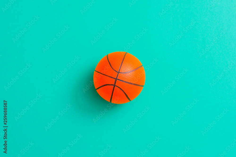 Orange basketball ball on a cyan  background