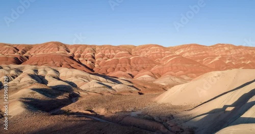 Flying over the red, colorful, rainbow mountains, covered with unique patterns, Iran. Aerial photography.