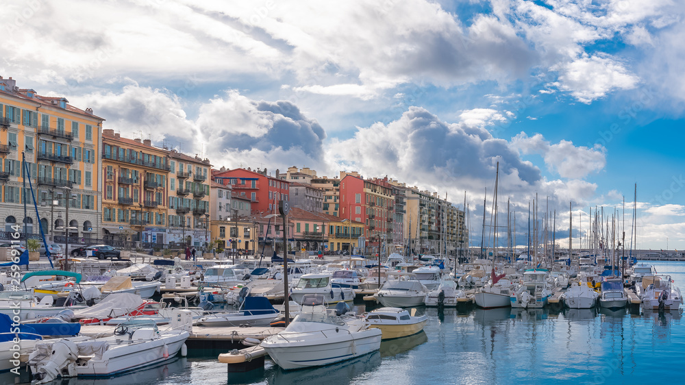 Nice in France, the harbor, old colorful buildings on the quays and boats in the marina 