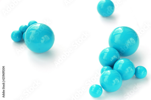 Fototapeta Naklejka Na Ścianę i Meble -  Abstract background of plastic blue beads of different sizes on a white background. copy space..