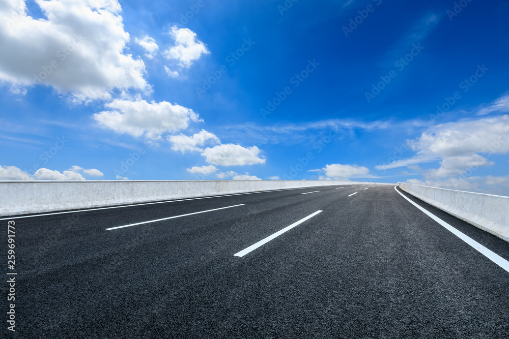 Empty asphalt road and blue sky with white clouds scene Empty asphalt road and blue sky with white clouds scene
