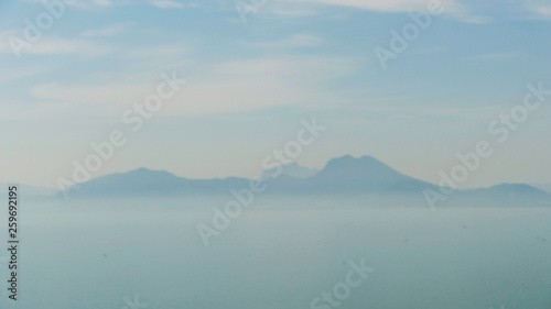 mountain island on the horizon in the fog
