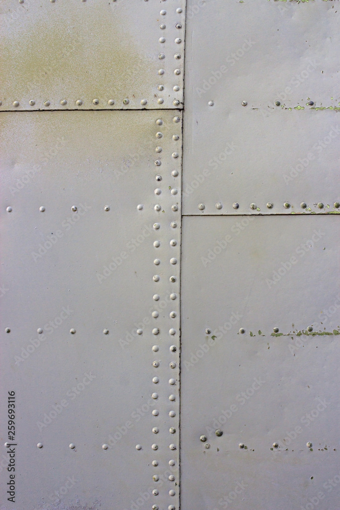 gray metal wall texture with seams and rivets