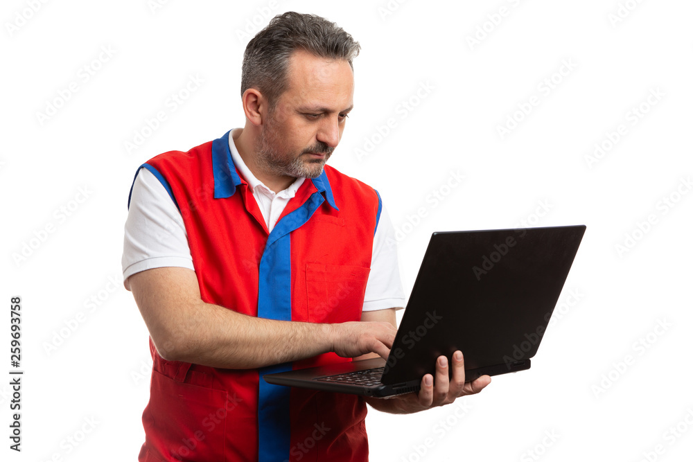Supermarket employee holding laptop. Supermarket employee holding laptop.