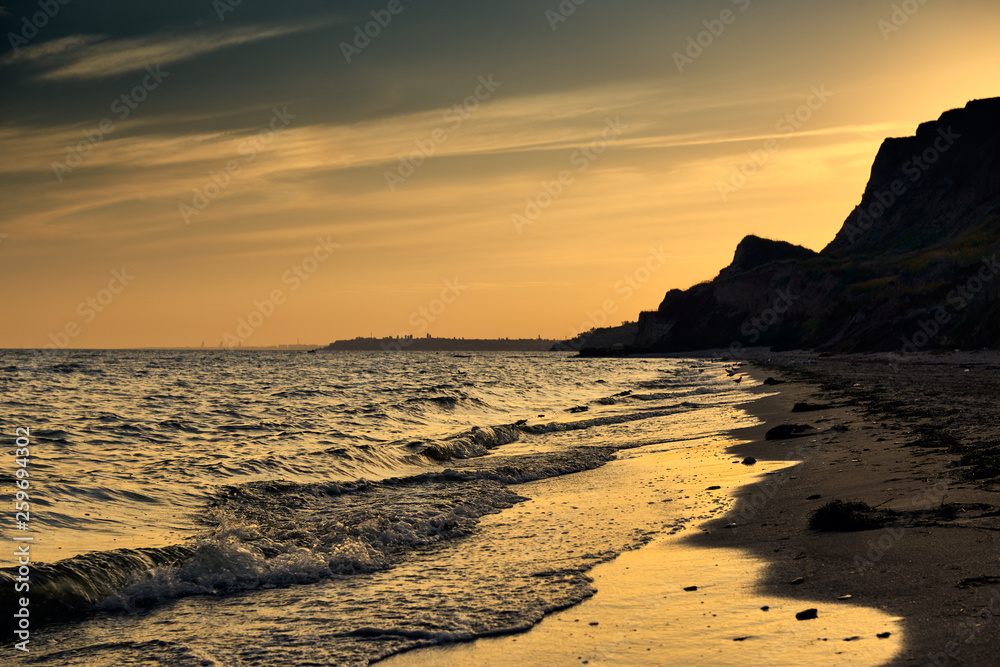 beautiful sunset, sea landscape, sea coast with high hills, wild nature