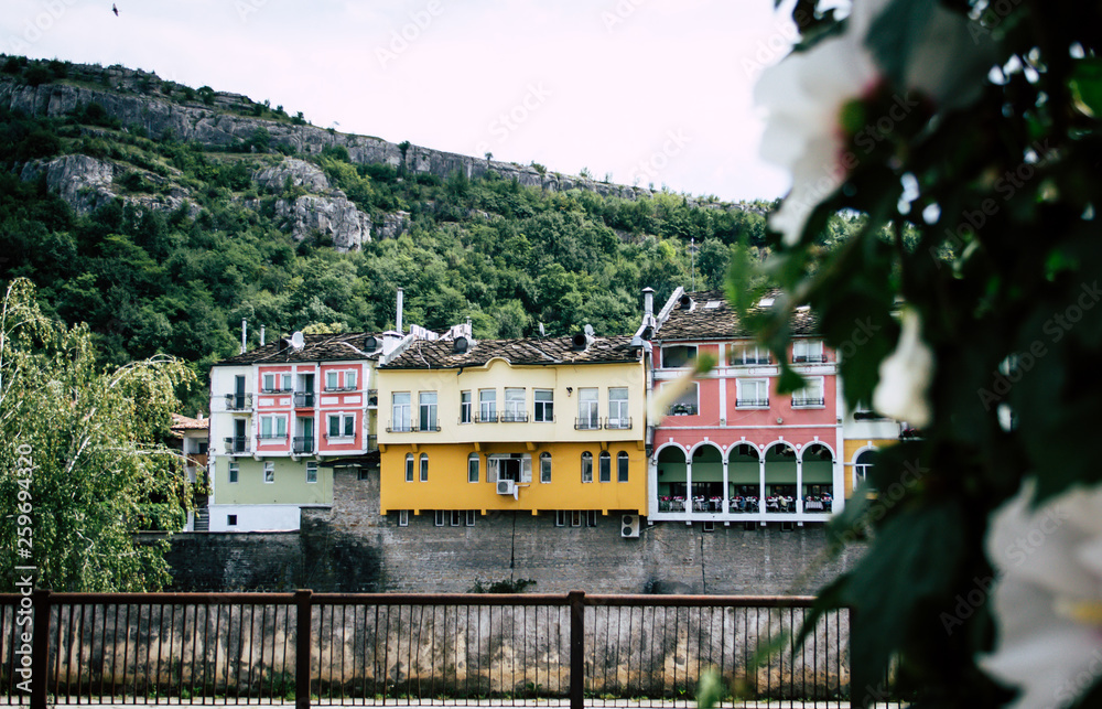 Historical colorful building facades over the river and a hill in Lovech, Bulgaria