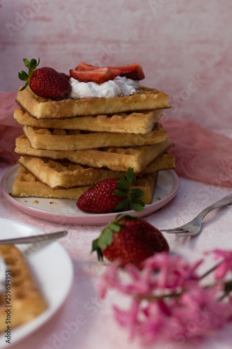 A stack of waffles with strawberries