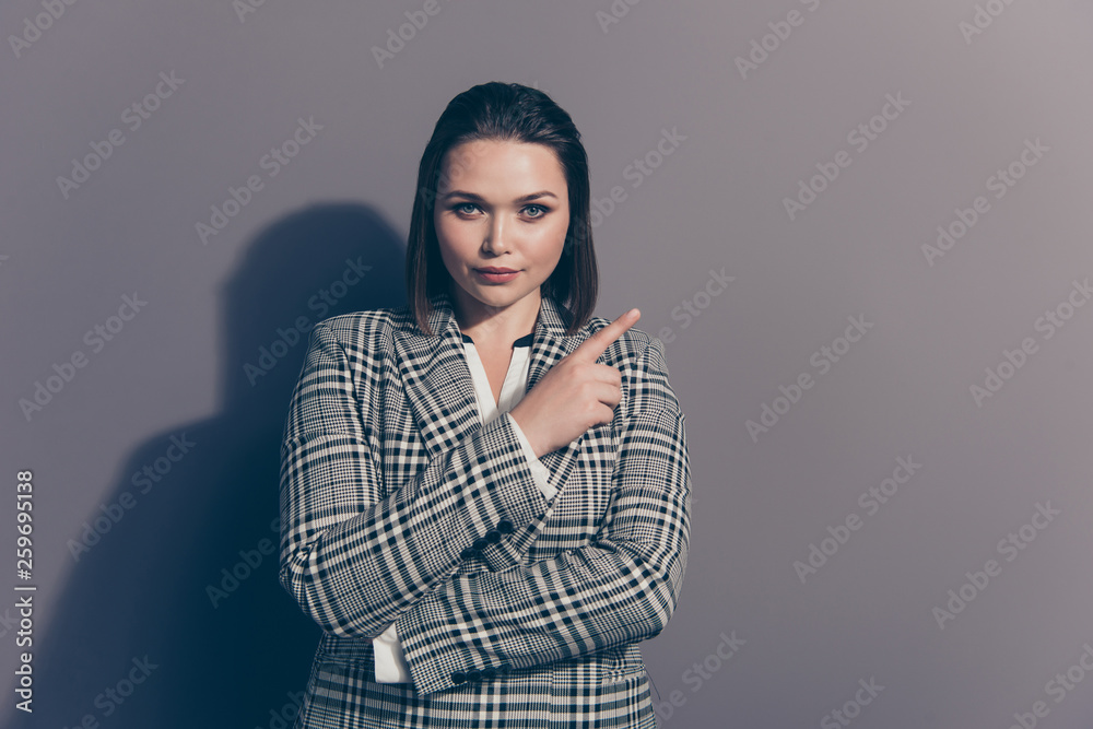 Fototapeta premium Closeup photo portrait of confident serious charming thoughtful office lady making choice pointing with forefinger looking at camera isolated grey background
