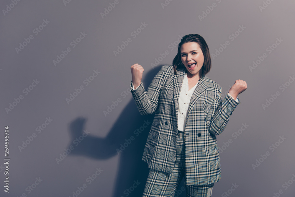 Closeup photo portrait of cheerful attractive cool with stylish hairstyle straight short hair holding fists hands arms up isolated grey background copy space Closeup photo portrait of cheerful attractive cool with stylish hairstyle straight short hair holding fists hands arms up isolated grey background copy space