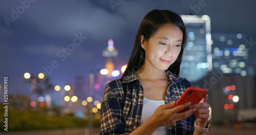 Photography Woman use mobile phone online at night