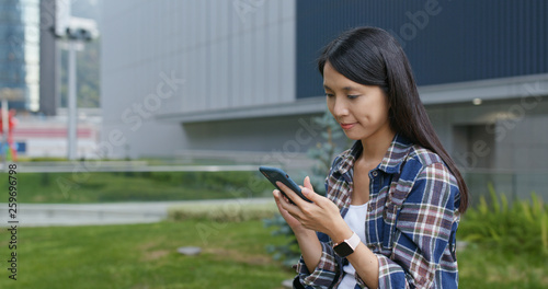 Photography Woman look at smart phone in city
