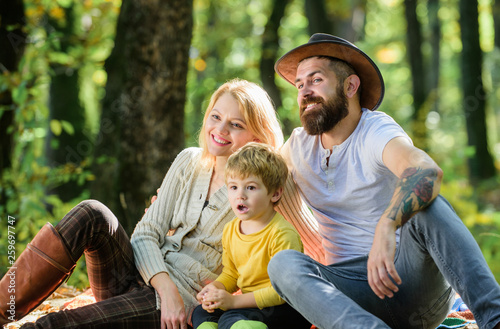 Happy son with parents relax in autumn forest. Sunny weather. Healthy food. Mother, cowboy father love their little boy child. Spring mood. Happy family day. Family picnic. Express positivity © be free