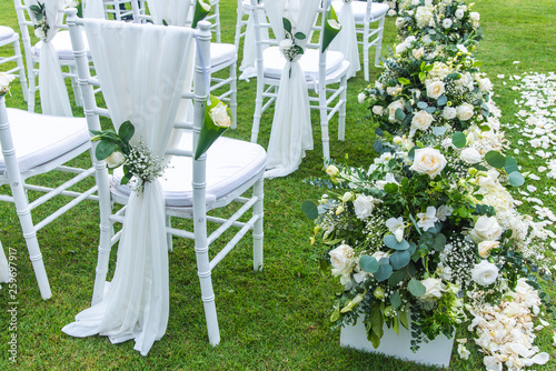 Chair decorated with flowers in Wedding ceremony.