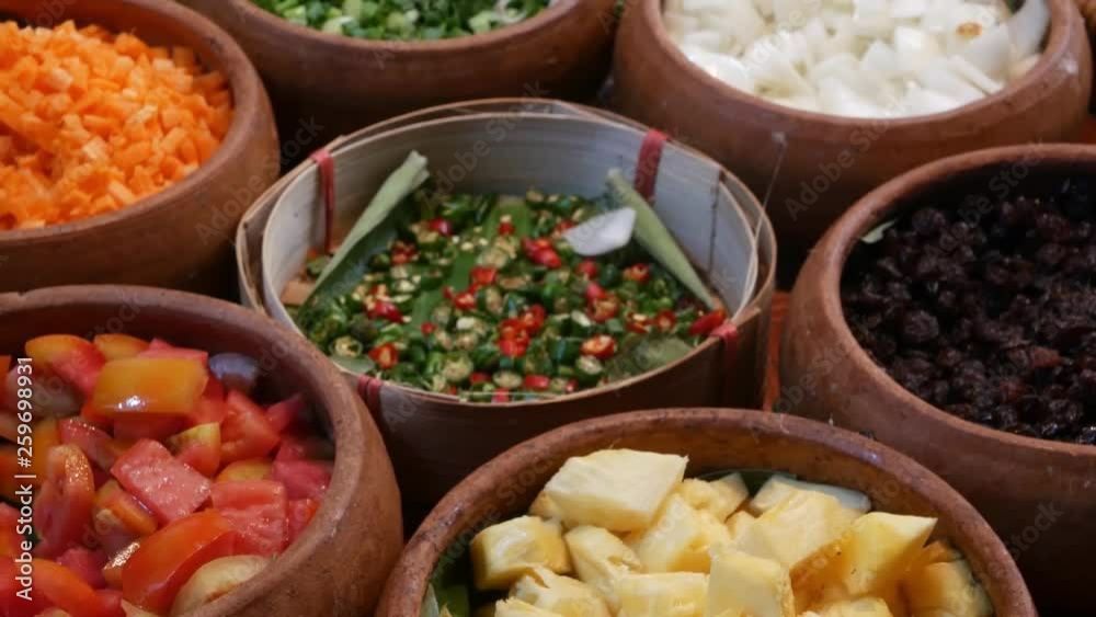 Top view of selection of various platters with delicious asian food and spices on a street market stall in Bangkok, Thailand