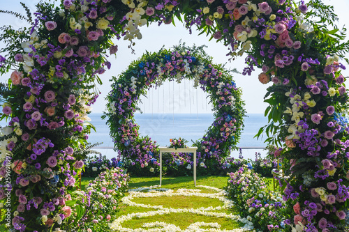 Wallpaper Mural Wedding ceremony. Arch, decorated with flowers on the lawn, beach background, sea in summer. Torontodigital.ca
