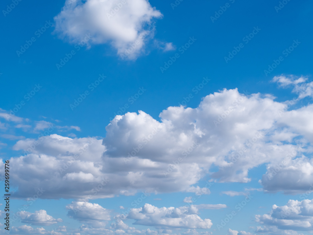 blue sky background with tiny clouds