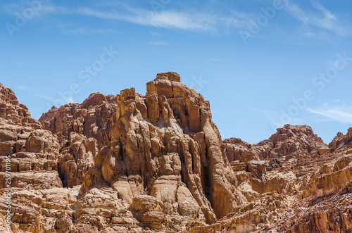 high rocky mountains against a blue sky and white clouds in Egypt Dahab South Sinai