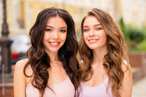 Close up photo of charming dreamy ladies fellows fellowship best students people have free time travelling trip long hair feeling cool confident wearing pastel clothing outside in town center © deagreez