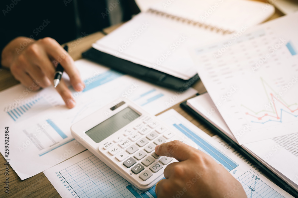 Two employees are calculating about the profit of the company after deducting expenses. Two employees are calculating about the profit of the company after deducting expenses.