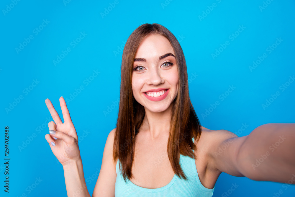 Close up portrait of lovely sweet cute teenager isolated having weekends holidays making photos v-signs on bright background Close up portrait of lovely sweet cute teenager isolated having weekends holidays making photos v-signs on bright background