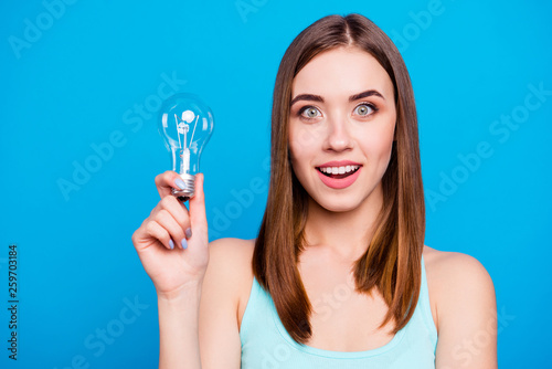 Close up photo beautiful amazing she her lady hold hands arms light bulb show symbolize candid intelligence dream dreamy nature wear casual tank top outfit clothes isolated blue bright background © deagreez