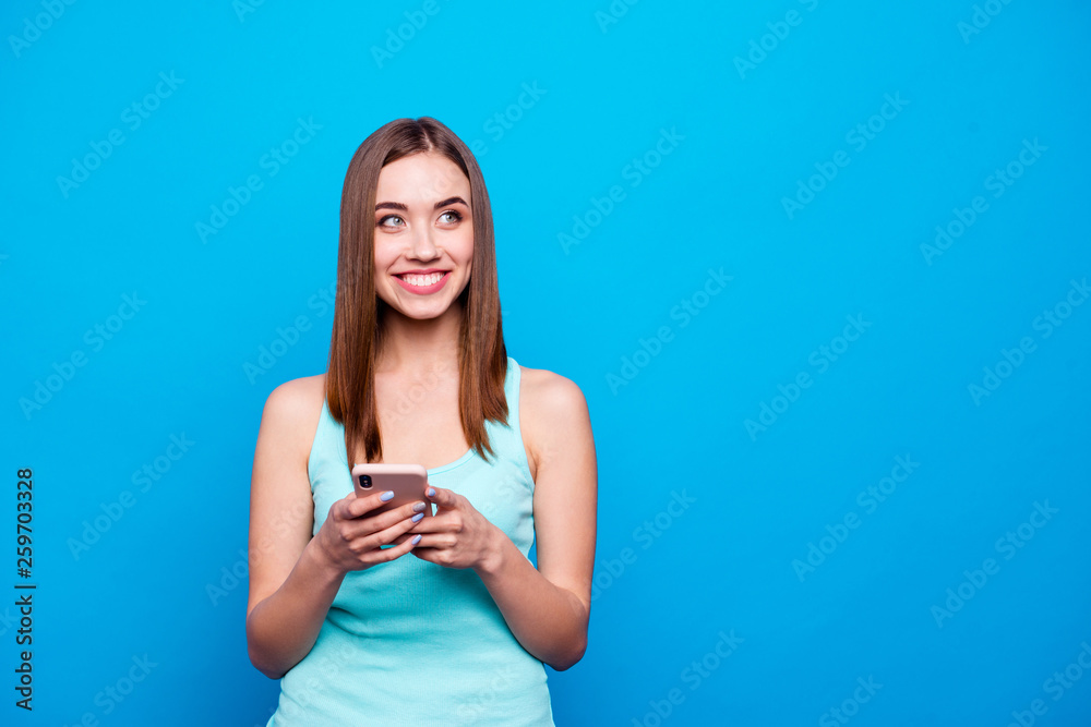 Close up photo beautiful amazing she her lady hold hands arms telephone smart phone look side empty space hear mom dad voices wear casual tank top outfit clothes isolated blue bright background Close up photo beautiful amazing she her lady hold hands arms telephone smart phone look side empty space hear mom dad voices wear casual tank top outfit clothes isolated blue bright background