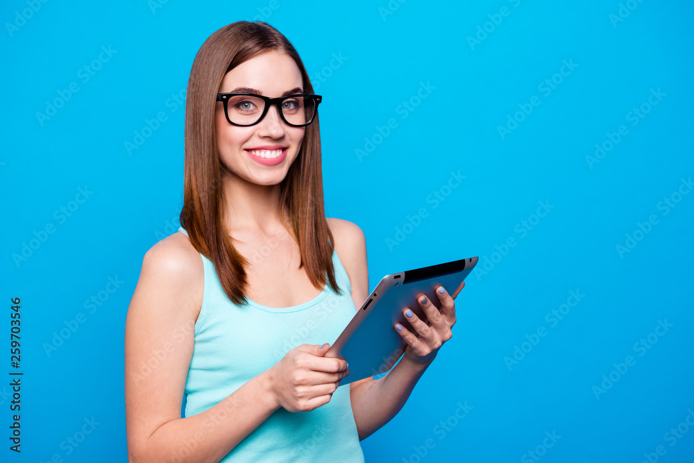 Close up photo beautiful amazing she her lady hold arms e-book read political financial news smart clever intelligent business person wear specs casual tank top clothes isolated blue background Close up photo beautiful amazing she her lady hold arms e-book read political financial news smart clever intelligent business person wear specs casual tank top clothes isolated blue background