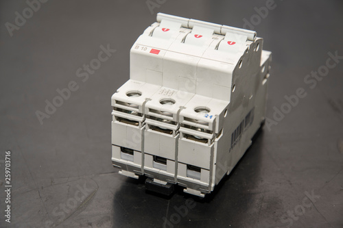 Three-phase circuit breaker lying on the table. photo