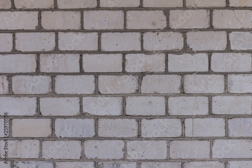 The brick texture, wall, with cracks and scratches can be used as a background