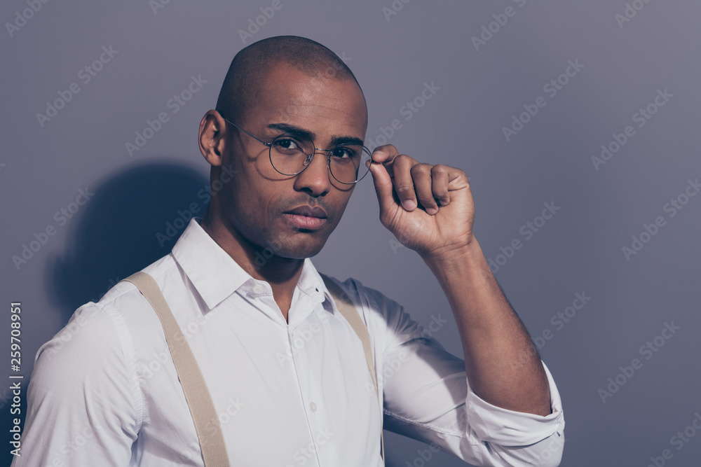 Close up side profile photo beautiful amazing dark skin he him his macho hand arm hold specs employer collar financier shaved face wear pastel suspenders white shirt isolated grey background Close up side profile photo beautiful amazing dark skin he him his macho hand arm hold specs employer collar financier shaved face wear pastel suspenders white shirt isolated grey background
