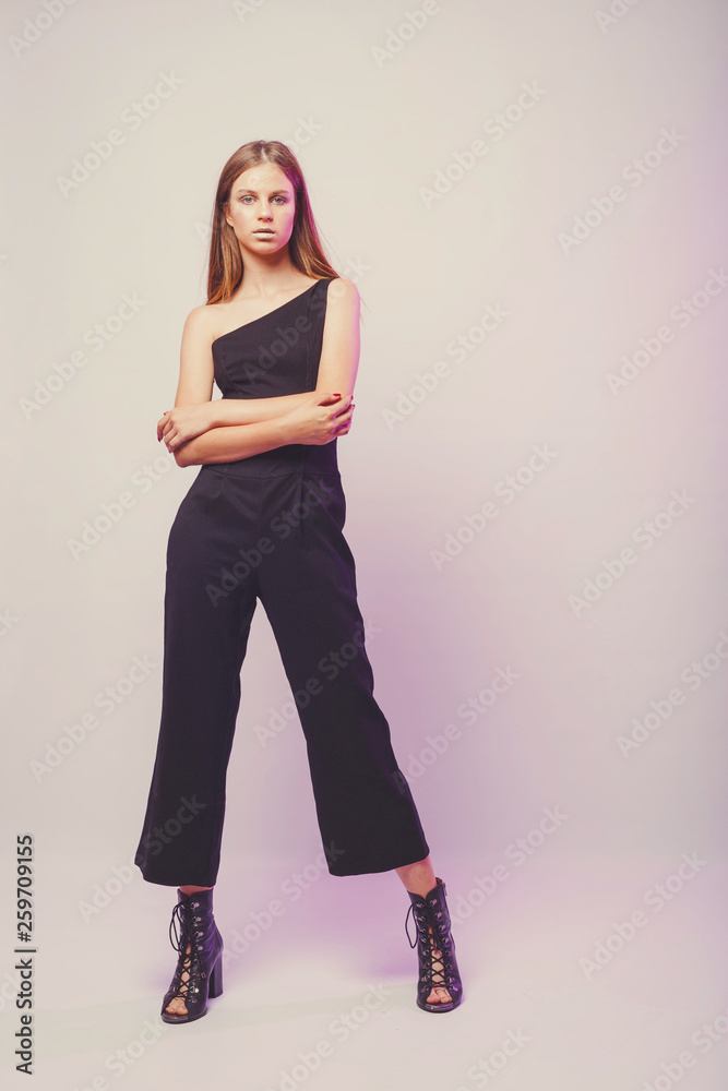 Fashionable girl in light tones in studio. Woman with unflappable face. Lifestyle concept in fashion world. Female in suit Fashionable girl in light tones in studio. Woman with unflappable face. Lifestyle concept in fashion world. Female in suit