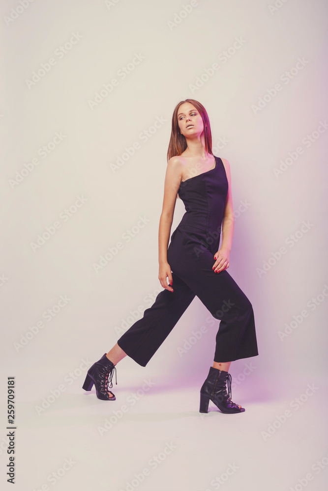 Fashionable girl in light tones in studio. Woman with unflappable face. Lifestyle concept in fashion world. Female in suit Fashionable girl in light tones in studio. Woman with unflappable face. Lifestyle concept in fashion world. Female in suit