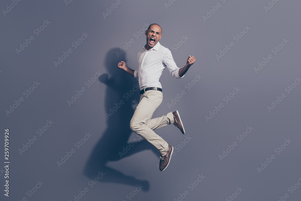 Obraz premium Full length side profile body size photo amazing yelling dark skin he him his macho jumping great mood cheerleader football baseball basketball wear white shirt pastel pants isolated grey background