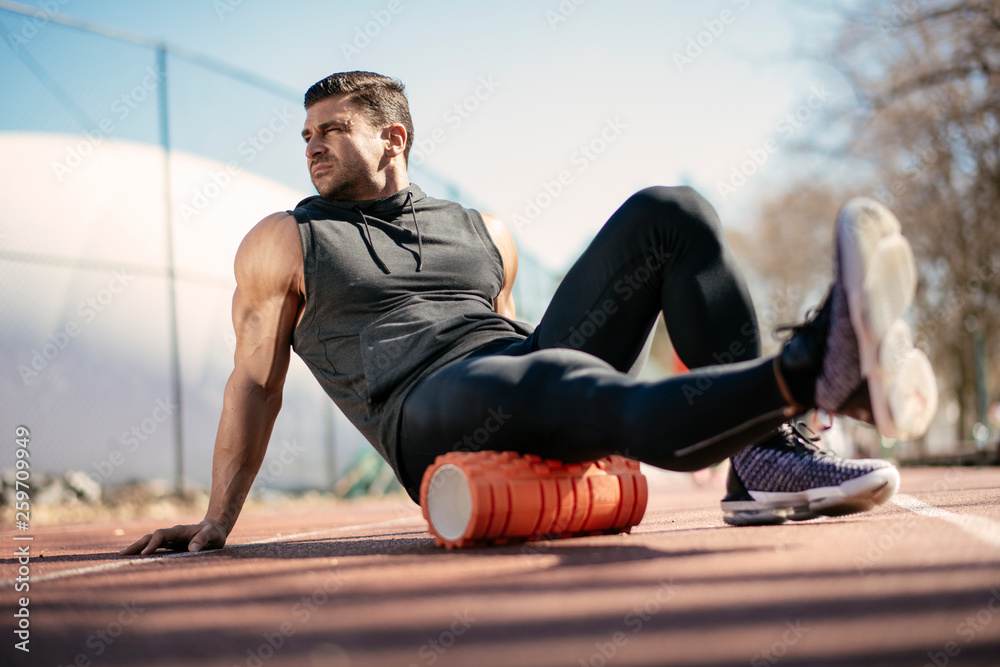 Young Man Stretching Himself On A Foam Roller Stock Photo - Download Image  Now - Foam Roller, Massaging, Stretching - iStock