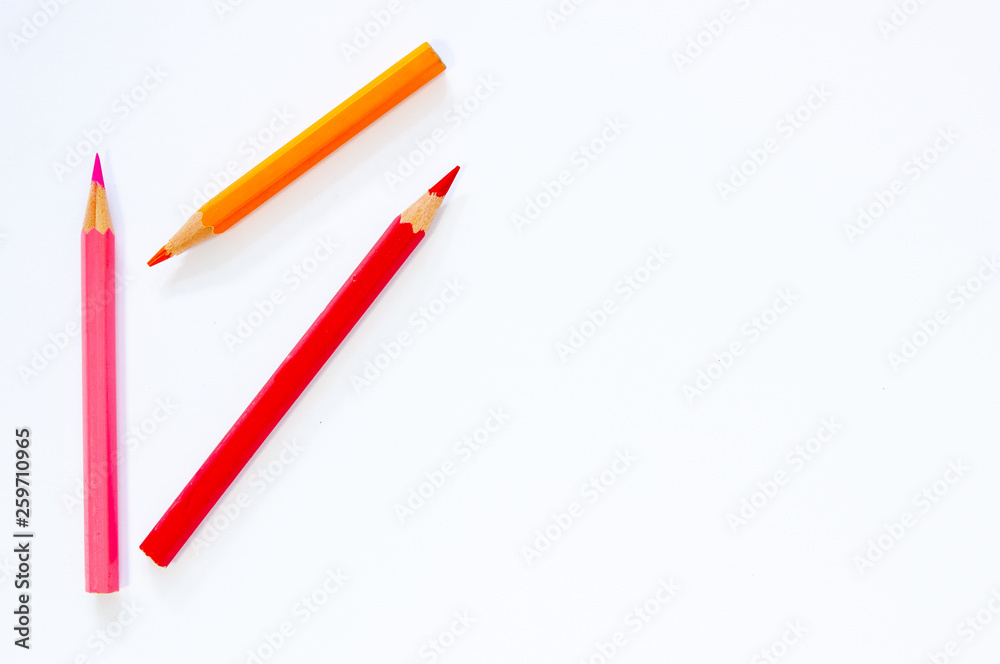 Colored pencils on white paper background. Colored pencils on white paper background.
