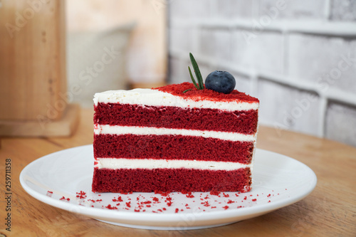 Red velvet cake on wood background.