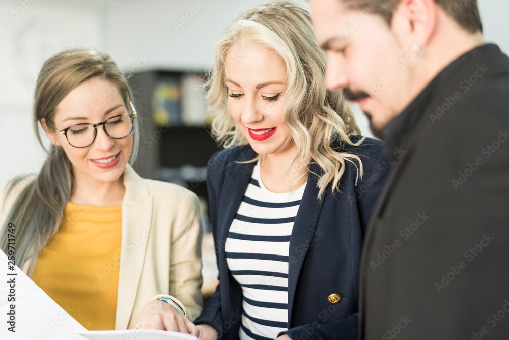 Partners working in office looking papers in office Partners working in office looking papers in office