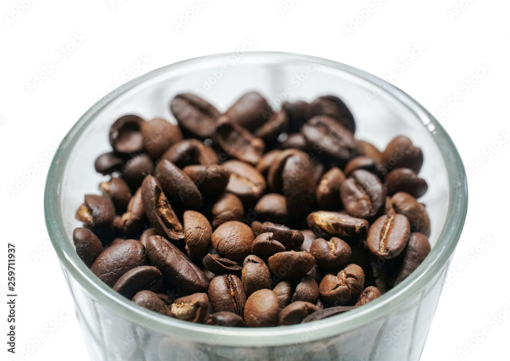Isolated coffee beans in a glass bowl on white background.