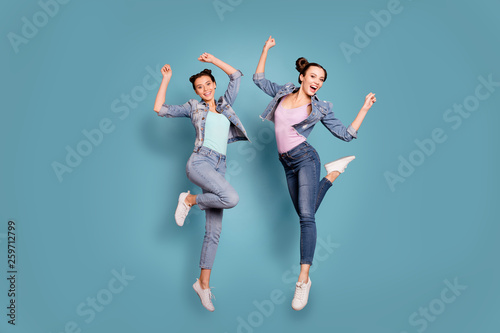 Full length body size photo of funky cute hipsters having promenade vacation fooling feeling excitement wearing denim outfit isolated over blue background