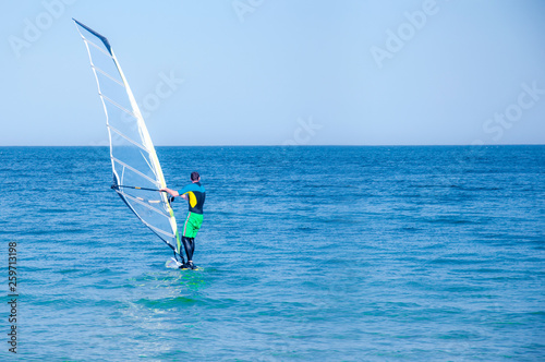 man windsurfing on the sea