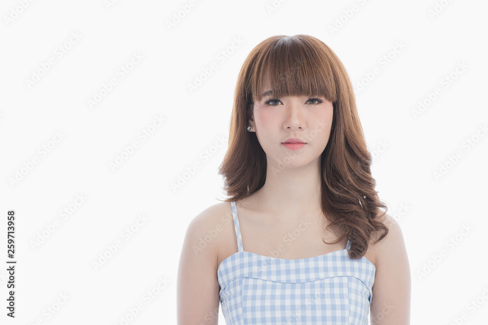 Front view close-up portrait of young beautiful Asian woman with curly long dark brown hair in light blue checked dress stand up straight and looking at camera on isolated white background Front view close-up portrait of young beautiful Asian woman with curly long dark brown hair in light blue checked dress stand up straight and looking at camera on isolated white background