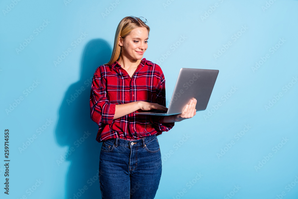Portrait of nice charming cute sweet lovely attractive winsome cheerful teen girl wearing checked shirt browsing stocks news isolated on teal turquoise bright vivid shine background Portrait of nice charming cute sweet lovely attractive winsome cheerful teen girl wearing checked shirt browsing stocks news isolated on teal turquoise bright vivid shine background